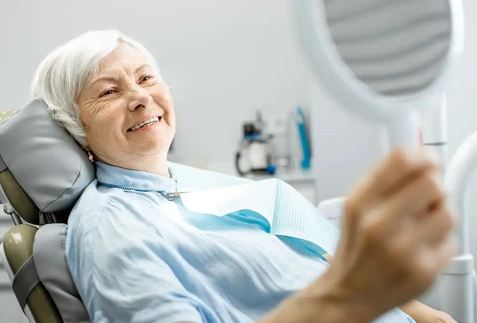 female-looking-mirror-dental-office.webp