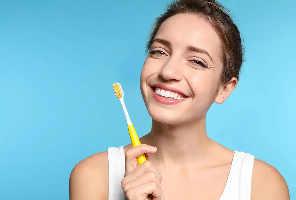 healthy-patient-holding-tooth-brush.webp